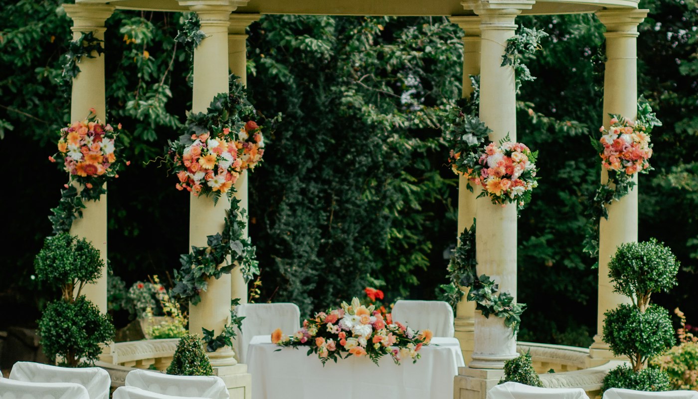 Flowers and place settings on a wedding reception table